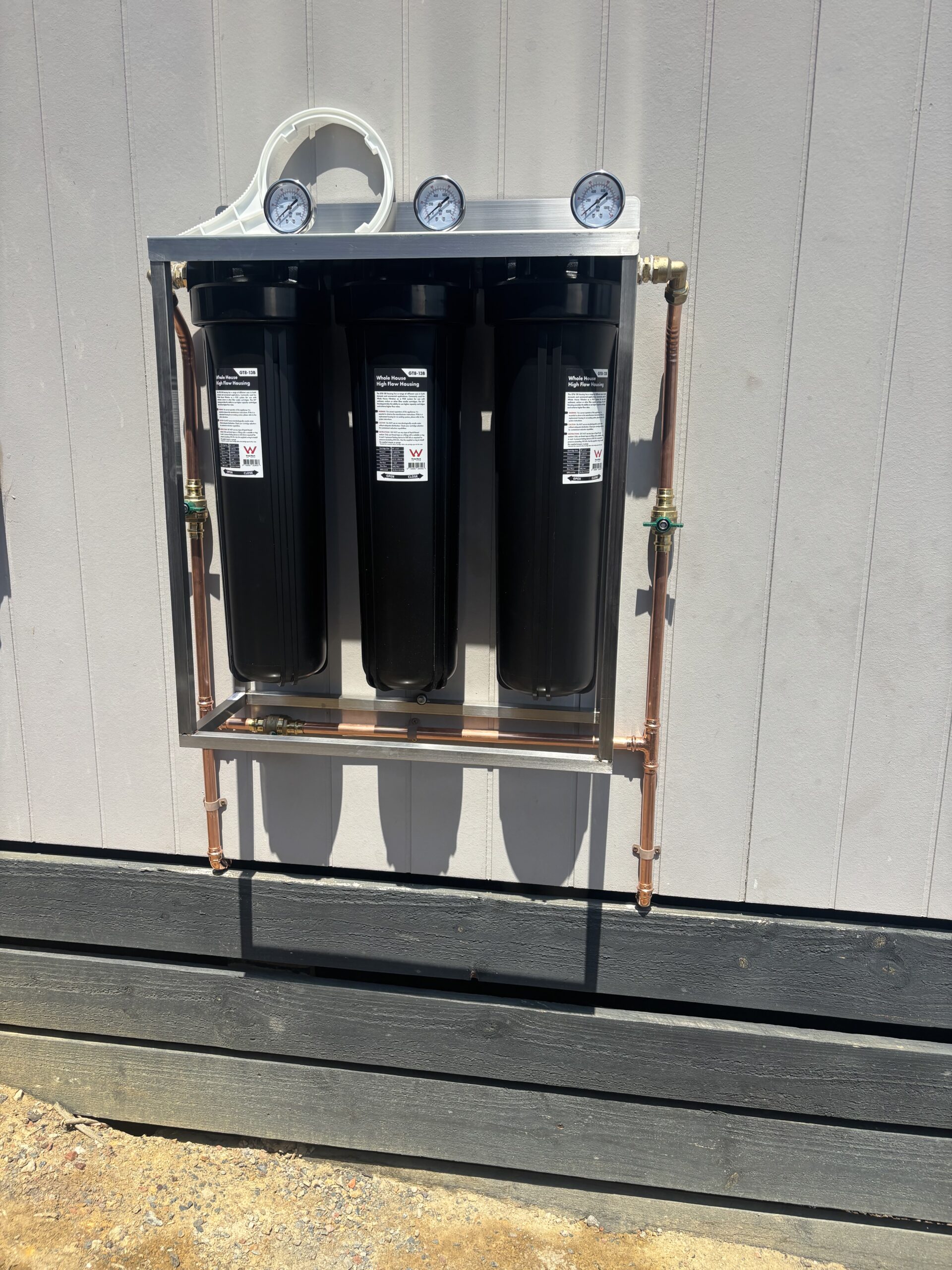 3-cylinder whole-home filtration unit on white wall