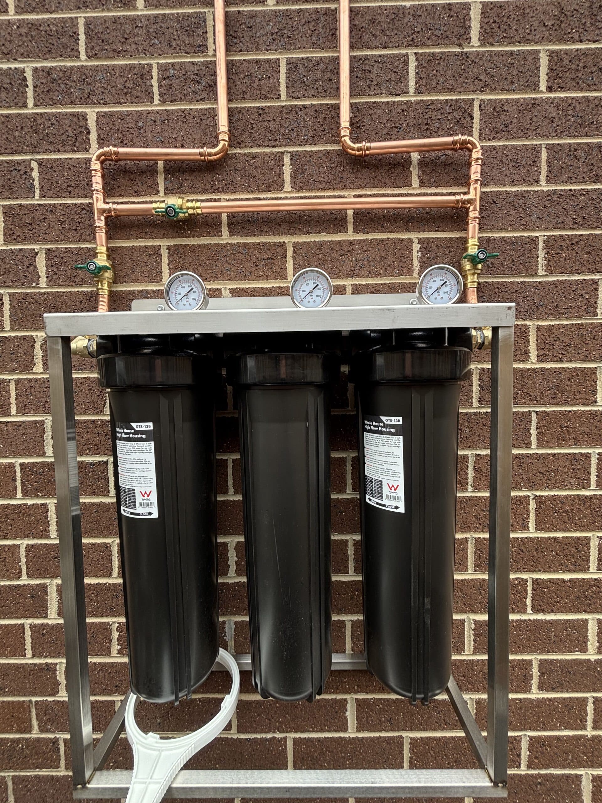 3-cylinder filtration unit installed on brick wall